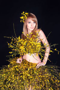 Portrait of woman with yellow flowers