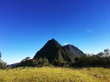 Scenic view of mountains against clear blue sky