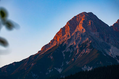 Low angle view of snowcapped mountains against clear sky