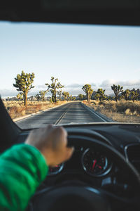 Midsection of man driving car 