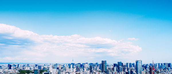 Modern buildings against cloudy sky