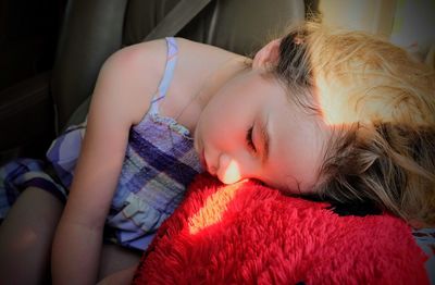 Cute girl sleeping on pillow in car