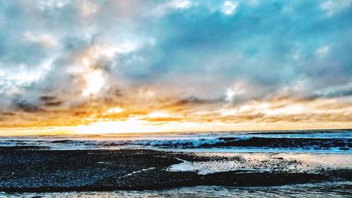 Scenic view of beach against sky during sunset