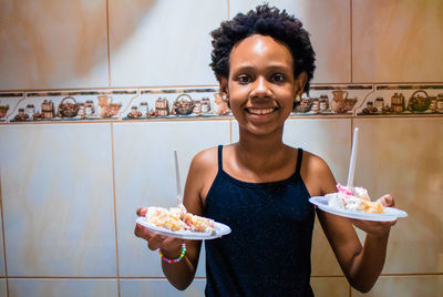 Portrait of smiling man holding ice cream