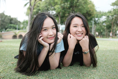 Portrait of smiling girl sitting on lawn