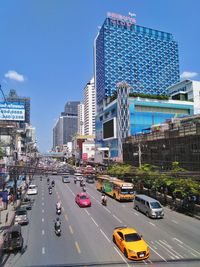 View of city street and buildings against sky