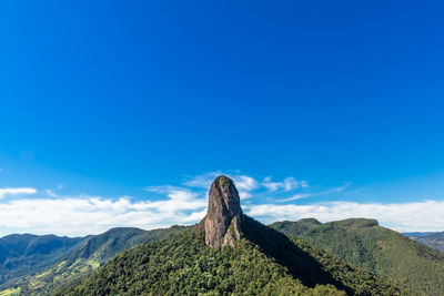 Scenic view of mountain against blue sky
