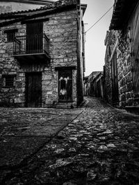 Street amidst buildings against sky