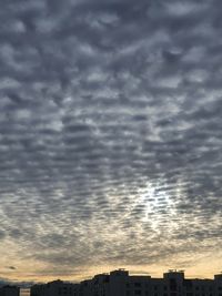 Low angle view of buildings against dramatic sky