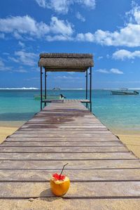 Long jetty leading to calm blue sea