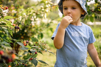 Portrait of boy against plants