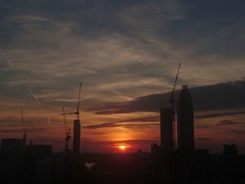 Silhouette built structure against sky during sunset