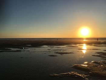 Scenic view of beach at sunset