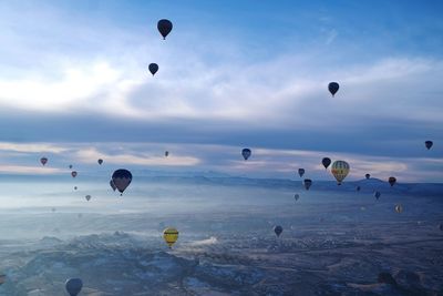 Low angle view of hot air balloons flying in sky