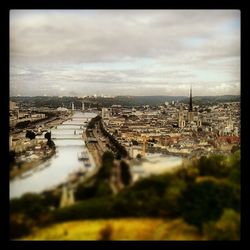 Cityscape against cloudy sky