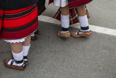 Low section of women standing on street