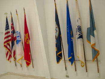 Low angle view of flags hanging against the wall