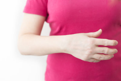 Midsection of woman with pink hair over white background