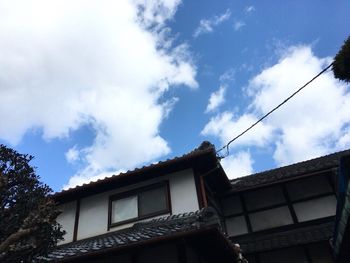 Low angle view of building against cloudy sky