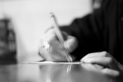 Close-up of hand holding cigarette