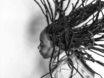 Happy boy tossing hair over white background