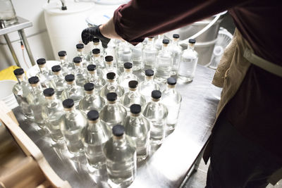 Bottles of liquor being capped at a distillery.