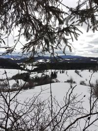 Scenic view of frozen lake against sky during winter