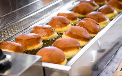 Close-up of breads frying in container