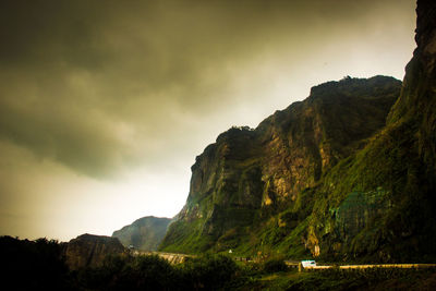 Scenic view of mountains against cloudy sky