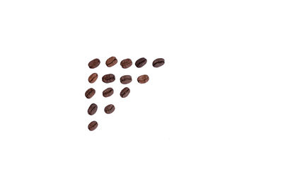 Close-up of coffee beans against white background