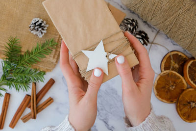 Cropped hands of woman holding gift box