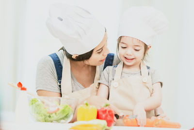 Happy mother and son on table