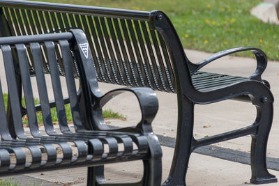 Close-up of empty benches on footpath