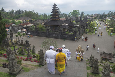 Rear view of people in temple outside building