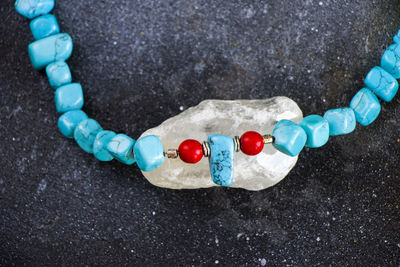 Colorful necklace and bracelet mix, beads and stone necklace, jewelry on the blue background