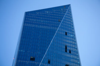 Low angle view of modern building against clear blue sky