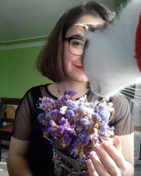 Portrait of beautiful woman holding flower bouquet with her cat