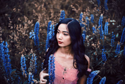 Portrait of beautiful young woman standing outdoors