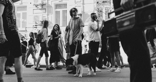 Group of people walking with dog in city