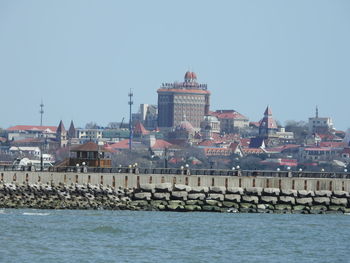 Buildings in city against clear sky