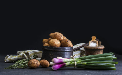 Close-up of vegetables on table against black background