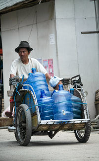 Side view of man riding motorcycle on street