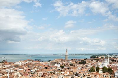 Townscape by sea against sky