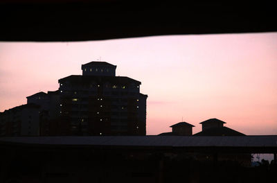 Low angle view of silhouette building against sky