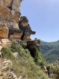 Rock formations on mountain against sky