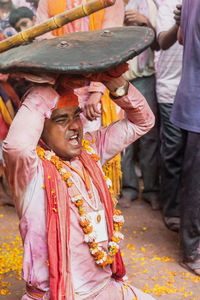 Full length of a man holding temple