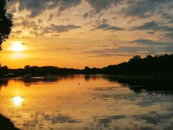 Scenic view of lake against orange sky