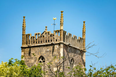 Low angle view of historical building against clear blue sky