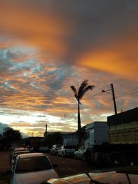 Cars on road against orange sky