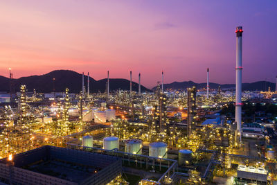 High angle view of illuminated buildings against sky at dusk